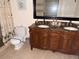 Elegant bathroom featuring a double sink vanity with dark wood cabinetry and a large mirror at 7031 Drury St, Tampa, FL 33635