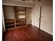 Bedroom featuring hardwood floors and a custom built-in closet system for ample storage at 7031 Drury St, Tampa, FL 33635