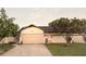Charming single-story home with a well-maintained lawn and two-car garage at 7031 Drury St, Tampa, FL 33635