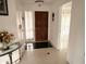 Inviting foyer with ceramic tile flooring, chandelier, and access to other rooms at 7031 Drury St, Tampa, FL 33635