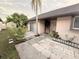 Attractive front entrance with stone pavers, mature landscaping, and a covered entryway at 7031 Drury St, Tampa, FL 33635