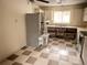 A kitchen area with modern appliances and checkered flooring at 7031 Drury St, Tampa, FL 33635