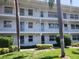 Condo building featuring multiple units with balconies and well maintained landscaping at 802 Brandy Wine Dr # 802, Largo, FL 33771