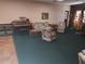 Bright community living room with a piano, floral furniture, and a view of the American Flag at 802 Brandy Wine Dr # 802, Largo, FL 33771