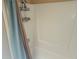 Bright shower with storage shelving and blue shower curtain at 802 Brandy Wine Dr # 802, Largo, FL 33771