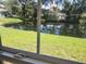 Gorgeous waterfront view from the window of this home, features green grass and calm water at 802 Brandy Wine Dr # 802, Largo, FL 33771