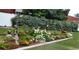 A lush garden is decorated with unique art and various flowers at 8101 Roxboro Dr, Hudson, FL 34667