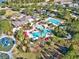 An aerial view reveals a pool area surrounded by palm trees, lounge chairs, and landscaping at 8320 Manor Club Cir # 4, Tampa, FL 33647