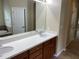 A bathroom with a double vanity, granite countertop, a soaking tub, and a separate room for the toilet at 8320 Manor Club Cir # 4, Tampa, FL 33647