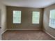 Spacious bedroom with carpet flooring, neutral walls, and abundant natural light from three large windows at 8320 Manor Club Cir # 4, Tampa, FL 33647