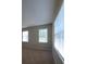A bright bedroom featuring neutral walls, carpet, and three large windows with blinds at 8320 Manor Club Cir # 4, Tampa, FL 33647