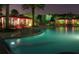A community pool at night with lounge chairs offers a beautiful and relaxing community space at 8320 Manor Club Cir # 4, Tampa, FL 33647