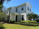 An angled view of the two-story home, showing the front entrance and garage at 8320 Manor Club Cir # 4, Tampa, FL 33647