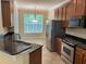 Kitchen area featuring granite countertops, stainless steel appliances, and dark wood cabinets at 8320 Manor Club Cir # 4, Tampa, FL 33647