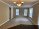 Spacious living room with wood-look floors and an elegant chandelier at 8320 Manor Club Cir # 4, Tampa, FL 33647