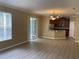 Living room open to kitchen; showcasing wood-look floors and ample natural light at 8320 Manor Club Cir # 4, Tampa, FL 33647