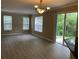 Open-concept living area featuring wood-look floors and sliding glass doors to the backyard at 8320 Manor Club Cir # 4, Tampa, FL 33647