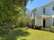 A view of the yard with lush lawn and landscaping at 8320 Manor Club Cir # 4, Tampa, FL 33647