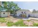 A view of the backyard featuring the home's rear exterior, a storage shed, and a partially paved area at 9445 Cardy St, New Port Richey, FL 34654