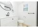 Modern bathroom featuring a vanity and a window at 9445 Cardy St, New Port Richey, FL 34654