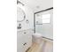 Bathroom featuring a walk-in shower with glass door, sleek fixtures, and modern design at 9445 Cardy St, New Port Richey, FL 34654