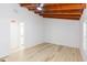 Bright bedroom featuring wood ceiling beams and light floors at 9445 Cardy St, New Port Richey, FL 34654