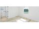Bright bedroom featuring light floors and a window at 9445 Cardy St, New Port Richey, FL 34654