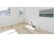 Minimalist bedroom with light floors, freshly painted white walls, and ample natural light at 9445 Cardy St, New Port Richey, FL 34654