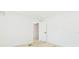 Bright bedroom featuring light floors and an open door at 9445 Cardy St, New Port Richey, FL 34654