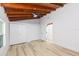 Bright bedroom featuring wood ceiling beams, light floors and multiple closets at 9445 Cardy St, New Port Richey, FL 34654
