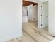 Inviting hallway with light wood floors and freshly painted white walls at 9445 Cardy St, New Port Richey, FL 34654