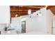 Bright kitchen with white cabinetry, stainless appliances, and vaulted ceiling with exposed beams at 9445 Cardy St, New Port Richey, FL 34654