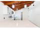 Bright kitchen with white cabinetry, quartz countertops, and vaulted ceiling with exposed beams at 9445 Cardy St, New Port Richey, FL 34654