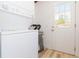 Laundry room with stacked washer/dryer and door to the outside at 9445 Cardy St, New Port Richey, FL 34654