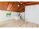 Open concept living room with wood floors, painted walls and stunning wood beamed ceilings at 9445 Cardy St, New Port Richey, FL 34654