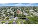 An aerial view of the home in a neighborhood with lush greenery at 9801 56Th N St, Pinellas Park, FL 33782
