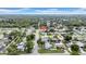 An aerial view displays the neighborhood in a tree-lined community at 9801 56Th N St, Pinellas Park, FL 33782