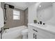 Clean bathroom featuring a shower-tub, modern vanity, and updated finishes at 9801 56Th N St, Pinellas Park, FL 33782