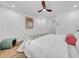 Bright bedroom with wood floors, ceiling fan and a comfortable bed at 9801 56Th N St, Pinellas Park, FL 33782
