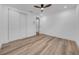 Bright bedroom with a ceiling fan, closet, and attractive vinyl plank flooring at 9801 56Th N St, Pinellas Park, FL 33782