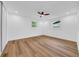 A bright, empty bedroom featuring wood floors, ceiling fan and windows for natural light at 9801 56Th N St, Pinellas Park, FL 33782