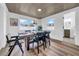 Bright dining room with wood-look floors, unique ceiling and a table set for a dinner party at 9801 56Th N St, Pinellas Park, FL 33782
