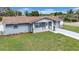 Well-maintained home with manicured lawn, freshly painted exterior, and stylish front porch at 9801 56Th N St, Pinellas Park, FL 33782
