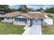 Beautiful home with manicured lawn, freshly painted exterior, and inviting front porch at 9801 56Th N St, Pinellas Park, FL 33782