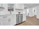 Modern kitchen featuring white cabinets, stainless steel appliances, and quartz countertops at 9801 56Th N St, Pinellas Park, FL 33782