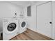 Convenient laundry room with modern Whirlpool washer and dryer, with easy access to plumbing at 9801 56Th N St, Pinellas Park, FL 33782
