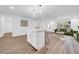 Open living space with kitchen island, flowing into a cozy living room and dining area at 9801 56Th N St, Pinellas Park, FL 33782