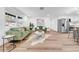 Open living space featuring wood floors, modern furnishings, and a seamless flow to kitchen at 9801 56Th N St, Pinellas Park, FL 33782