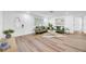 Bright living room featuring wood-look flooring, neutral walls, and comfortable seating at 9801 56Th N St, Pinellas Park, FL 33782