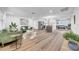 Open concept living room with wood floors seamlessly flows into the kitchen and dining area at 9801 56Th N St, Pinellas Park, FL 33782